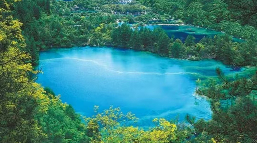 Long Lake surrounded by mountains and forests at high altitude